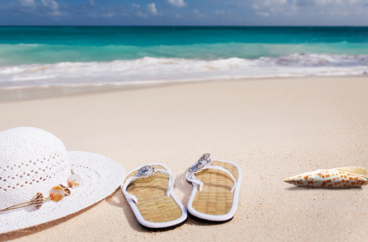 A cap, Sandals, Sea shell before sea shore.